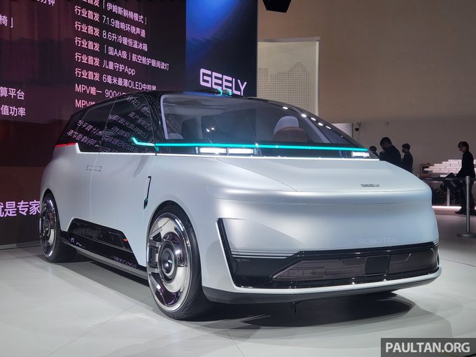 A sleek silver concept car is displayed at an auto show with 'GEELY' branding visible on a screen behind it, and a 'paultan.org' watermark in the corner.