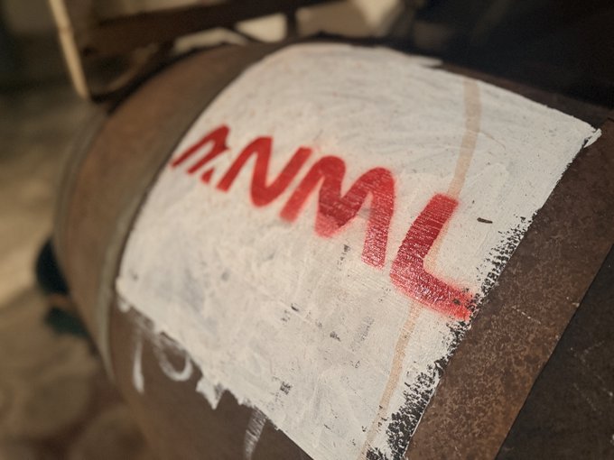 The image features a close-up view of a barrel, which has been marked with red paint that reads "ANML quants" or "@XeroDestroys what was meant for this channel, but we'll let it stand". The barrel is placed on a surface and appears to be in good condition. The text on the barrel seems to be related to an online platform called "@XeroDestroys", which might be discussing or promoting some sort of content or product.