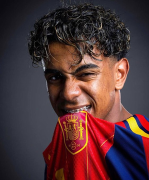 A young man with curly hair playfully bites the collar of a red and blue Spanish national team jersey featuring the "RFEF" crest, his expression intense and celebratory—reflecting the post's excitement about a high-stakes bet on Spain to win a championship at just 13 cents per share.