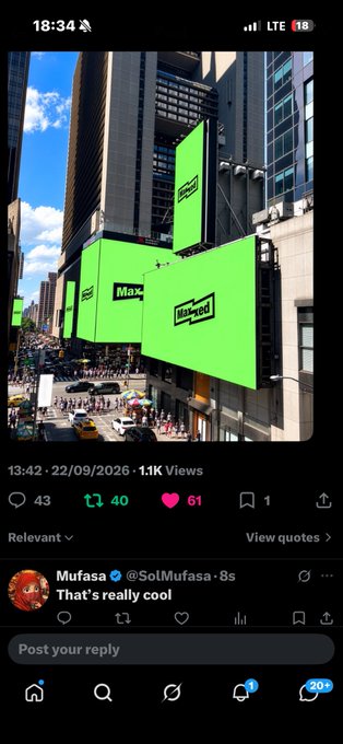 A screenshot of a social media post showing bright green billboards reading "Mawred" in a city, with a reply from "Mufasa" saying "That's really cool".
