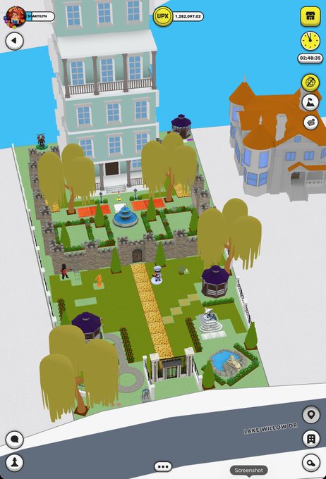 A screenshot of a mobile city-building or life simulation game showing a landscaped yard with a maze-like hedge garden, trees, and statues next to a light blue building.