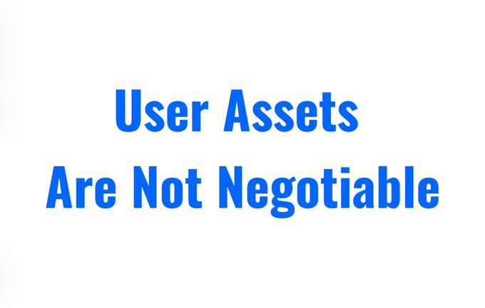The image features a white sign with blue text that reads "User Assets are not Negotiable" written in black letters against a gray background. The sign appears to be posted or displayed, possibly for an advertisement or informational purpose related to user assets.