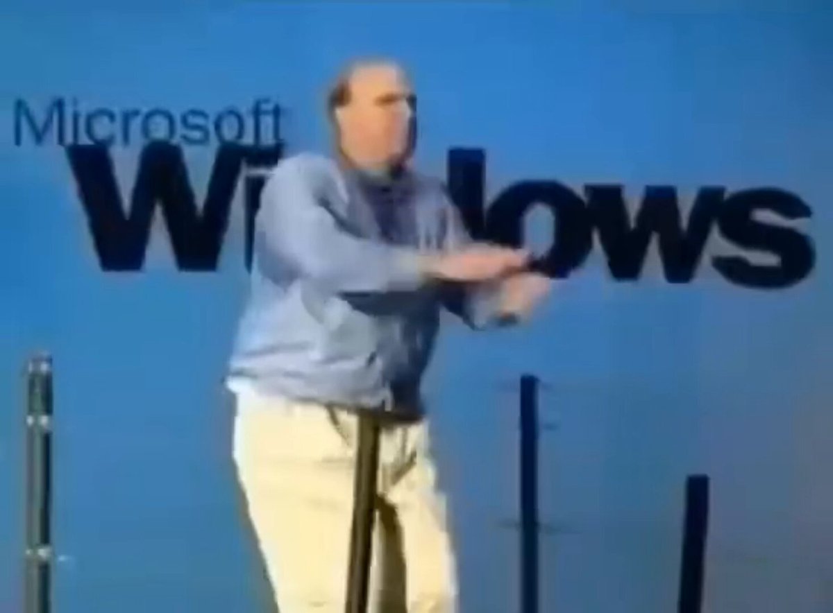 The image features a man dressed in a blue shirt, standing against a blue background with Microsoft Windows written across it. The text "Announcing the GOAT Network Developer Advocate Program" can be seen at the bottom of the image. This suggests that there might be an event or promotion related to software development and technology, possibly involving the adoption of AgentKit as part of the GOAT network.
