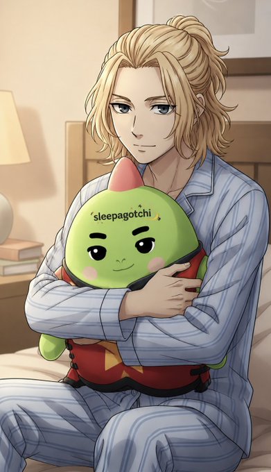 The image features a man sitting on a bed holding a green stuffed animal with a face. The man has blonde hair and is wearing pajamas. There are books visible near him, suggesting that he might be reading or studying before going to sleep. The image also includes text that reads "Most Web3 projects chase attention. Few build around daily habits. @sleepagotchi does. They’re designing for something people do every day: sleep. By gamifying better $SLEEP, they make consistency fun instead of just tracking stats." This implies a connection between the man's pajamas and his interest in web3 projects that focus on improving daily habits or routines.