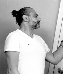 A bearded man with a top knot, wearing a white t-shirt, stands in profile gazing toward a canvas, embodying the creative process behind the NFT collection. The image visually reinforces the post's theme of "THE ARTIST | THE PROCESS," highlighting the handcrafted effort behind the four physical 60x48" canvas pieces tied to the NFTs.