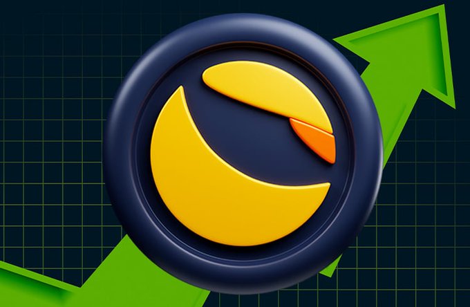 The image features a logo for a company named "Luna". The logo consists of a circle with a yellow sun inside, surrounded by blue lines. The background of the image is black, which contrasts with the vibrant colors of the logo. Below the logo, there's an upward-pointing arrow that points to the right side of the image. The text in the image reads "How do you feel about $LUNC this year?". This suggests that the company might be discussing or promoting their stock trading services and analyzing the performance of a particular stock.