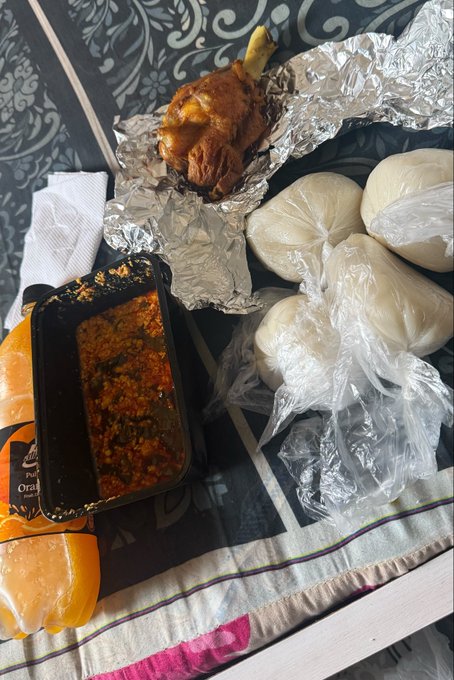 A breakfast feast featuring foil-wrapped fried chicken, biscuits in plastic bags, a tray of seasoned rice and beans, and orange soda is laid out on a tray, humorously offsetting the "take $7 out of your portfolio today" caption as a relatable splurge meal for budget-conscious investors.