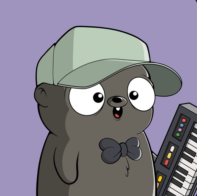 A cartoon illustration of a dark gray seal-like character wearing a green cap and a dark bow, holding a keyboard with colorful buttons.