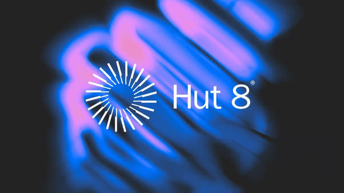 The image displays the Hut 8 logo, featuring a stylized blue and pink burst design next to the company name "Hut 8®." This aligns with the post about Benchmark raising Hut 8's price target following the expansion of its Beacon Point AI campus and its transformation into a "power-first data center REIT" with $26.6 billion in contracted revenue.