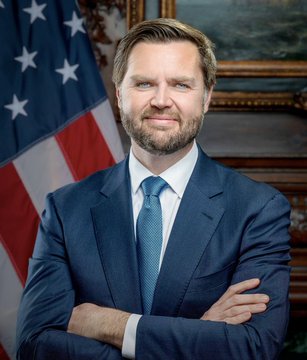 An official portrait shows Vice President J.D. Vance in a blue suit with arms crossed, standing in front of an American flag.