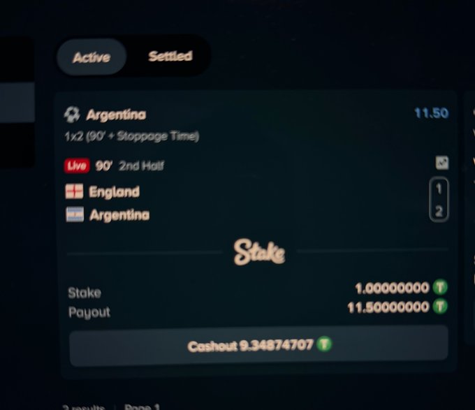 A Stake sports betting interface showing an active bet on an Argentina vs England match at 11.50x odds, live at 90 minutes in the 2nd half, with England leading 1-2.