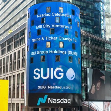 The Nasdaq tower displays a celebratory announcement for Mill City Ventures III's name and ticker change to SUIG (SUI Group Holdings), marking its listing on Nasdaq. This visual directly ties to the post by showcasing the public milestone of the SUI Group Holdings, which is actively expanding its lending capacity and funding Bluewater's acquisition of Suilend on the SUI blockchain.