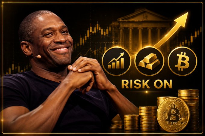 A smiling man in a black shirt poses next to financial graphics showing an upward arrow, gold coins, and the words 'RISK ON' alongside growth, gold, and Bitcoin symbols.