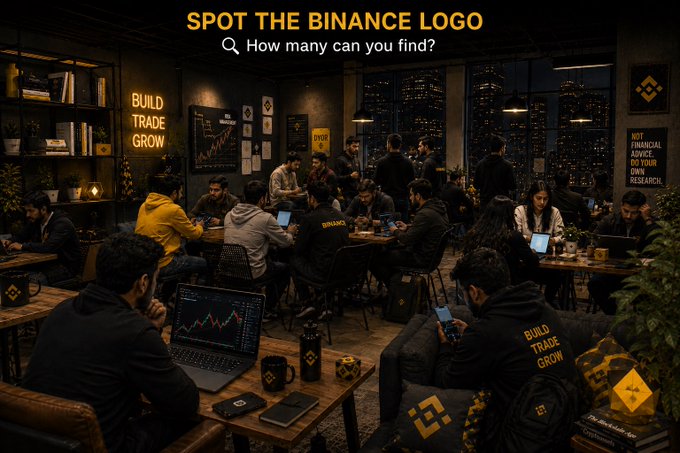 A dimly lit, crowded workspace scene under the text 'SPOT THE BINANCE LOGO - How many can you find?', showing people at tables with laptops and Binance-branded merchandise.