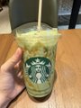A hand holds a Starbucks iced matcha latte, identifiable by the green siren logo on the cup. The post warns about tax obligations for crypto and DEX trading, humorously implying the user is taking a coffee break from dealing with regulatory headaches.