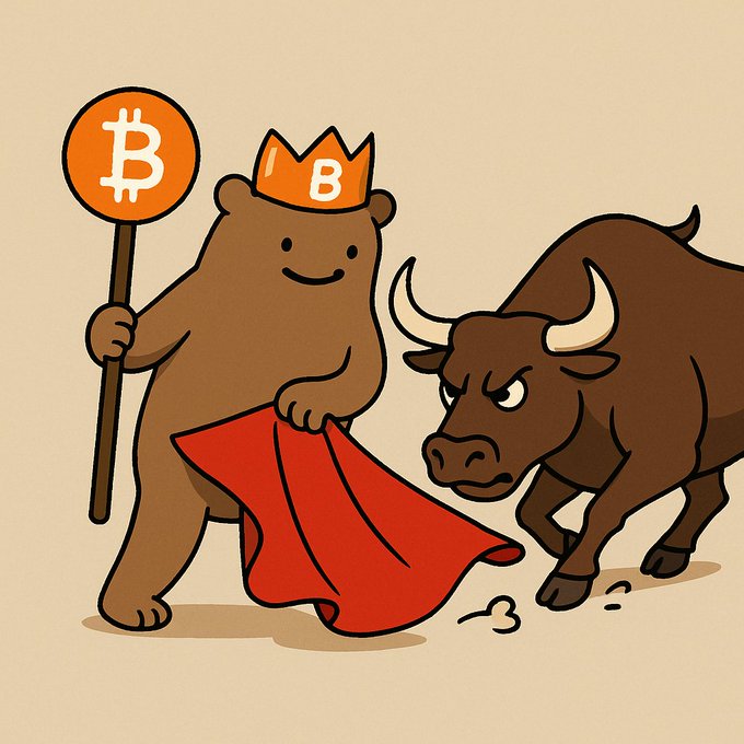 A cartoon illustration depicting a bear wearing a Bitcoin crown and holding a "B" sign and red cloth, facing off against an angry charging bull — a classic representation of crypto market sentiment.
