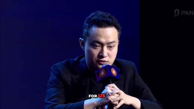 Justin Sun, founder of the TRON blockchain ecosystem, is shown speaking at what appears to be a PANews event, with the subtitle "FOR US" displayed. The image relates to the post by highlighting the leader behind TRON's recent achievements, including its $28.15 billion TVL and over 400 million accounts.