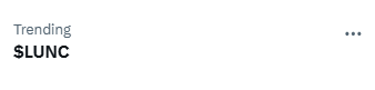 A minimalist header displays "Trending" and "$LUNC" in bold black text on a light backdrop, with a three-dot menu icon in the upper right, suggesting a social media or news feed section highlighting the trending cryptocurrency ticker mentioned in the accompanying post about an upcoming significant event.