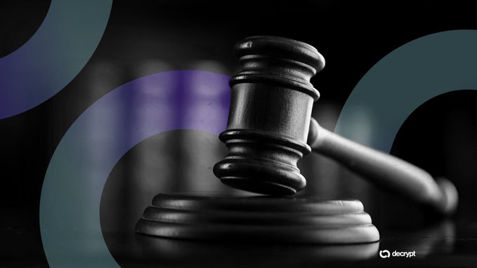 A black and white image of a wooden gavel resting on its block, with a Decrypt watermark.