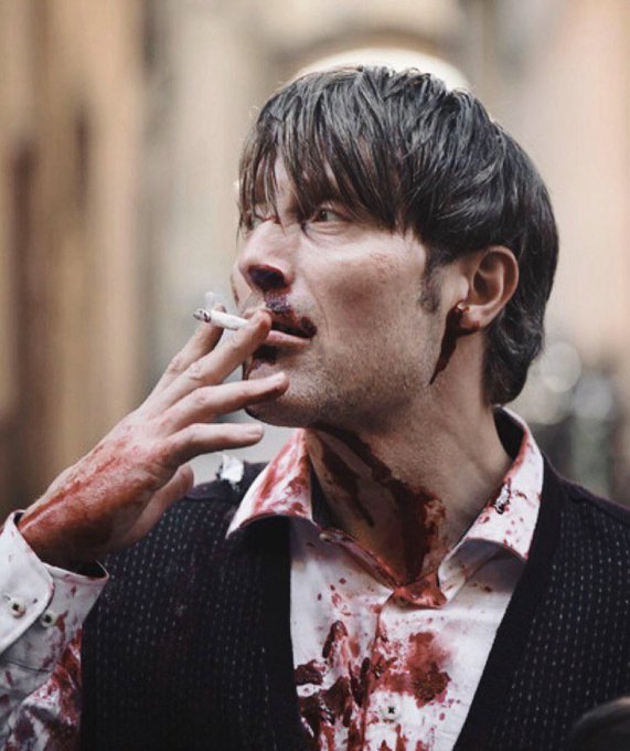 A man with bloodstains on his face and shirt, Mads Mikkelsen as Hannibal Lecter, smokes a cigarette. The image reflects the post's sentiment of overcoming a difficult and toxic period.