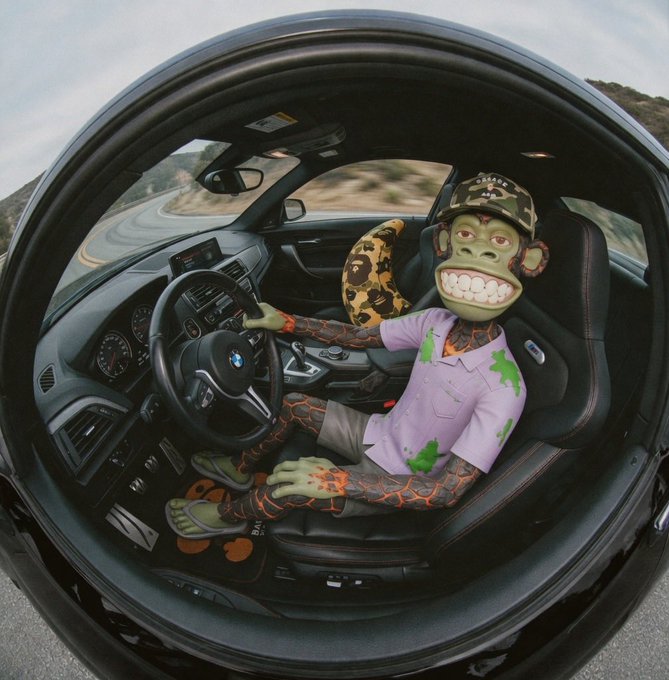 The image features a monkey sitting inside a car with its foot on the steering wheel. The monkey appears to be wearing a hat and has a green shirt, giving it a unique appearance. The car's interior includes a seatbelt visible near the driver's side door. In the background, there is a road or highway that suggests the scene takes place in an urban setting.

The image also contains text that reads "membership paid, I'm chillin' for real bored ape yacht club". This could be a reference to a car club or event where members can enjoy driving and socializing with others who share their passion for cars and unique experiences.