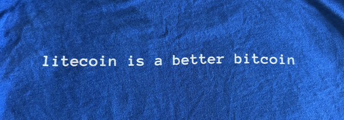 A blue fabric shirt displays the white typewriter-style text "litecoin is a better bitcoin" printed across the center, turning the long-running crypto slogan into wearable apparel.