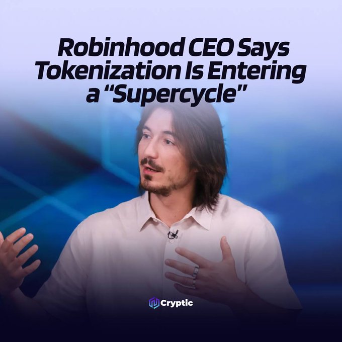 The picture shows a man with shoulder-length brown hair, a goatee, and a white button-up shirt, gesturing with both hands as he speaks, overlaid with the headline "Robinhood CEO Says Tokenization Is Entering a 'Supercycle'" against a blue geometric background, and branded with the "Cryptic" logo—visually accompanying the post about Vlad Tenev's prediction that tokenization will reshape how financial assets are issued, traded, and settled.