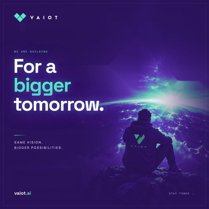 VAIOT promotional poster with purple cosmic background, text reading 'WE ARE BUILDING For a bigger tomorrow. SAME VISION, BIGGER POSSIBILITIES. vaiot.ai STAY TUNED...' and a silhouetted figure sitting on a peak overlooking Earth.