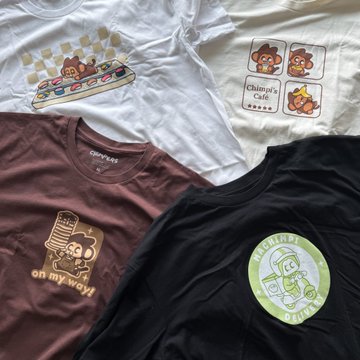 Three Chipotle-themed t-shirts laid out, featuring designs like a burrito ('oh my wow!'), a mario kart style graphic, and a 'Chipotle's Cafe' monkey design.