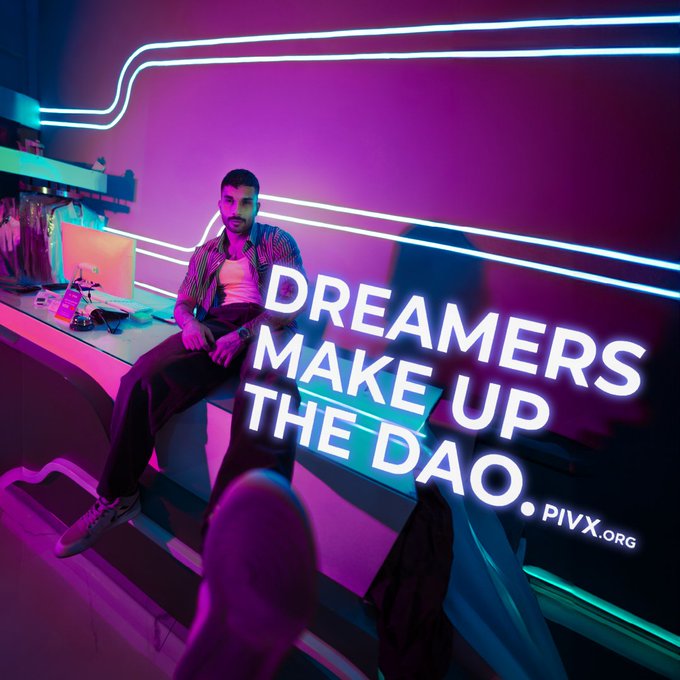 A neon-lit promotional image shows a person sitting on a counter with bright neon text reading 'DREAMERS MAKE UP THE DAO. PIVX.ORG' against pink and blue lighting.