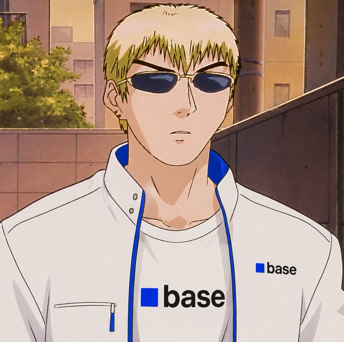 The image features a man wearing sunglasses and a white shirt with blue lettering that says "base" on it. The man appears to be looking off into the distance or at someone who isn't visible in the frame, suggesting he might be waiting for something or someone. The surrounding environment consists of buildings, indicating an urban setting. There is also text present in the image, which reads: "What do you think @base is preparing for us? A lot of people are already speculating about a possible snapshot". This implies that there could be speculation or anticipation regarding a potential event related to base, possibly involving a new product release or an upcoming photo shoot.