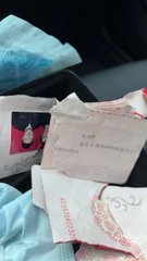A photograph showing Turkish currency banknotes (50 lira) and a face mask resting on a car seat.