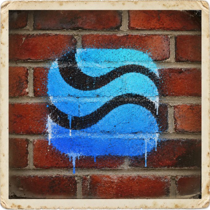 Street art featuring a stylized blue 'S' logo (Waveswap) spray-painted on a red brick wall.