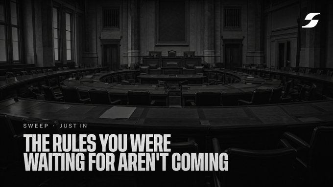 An empty, darkened congressional chamber is overlaid with the bold text "THE RULES YOU WERE WAITING FOR AREN'T COMING," visually reinforcing the message that the Clarity Act and meaningful crypto regulation have stalled in a vacant legislative body rather than advancing toward a vote.