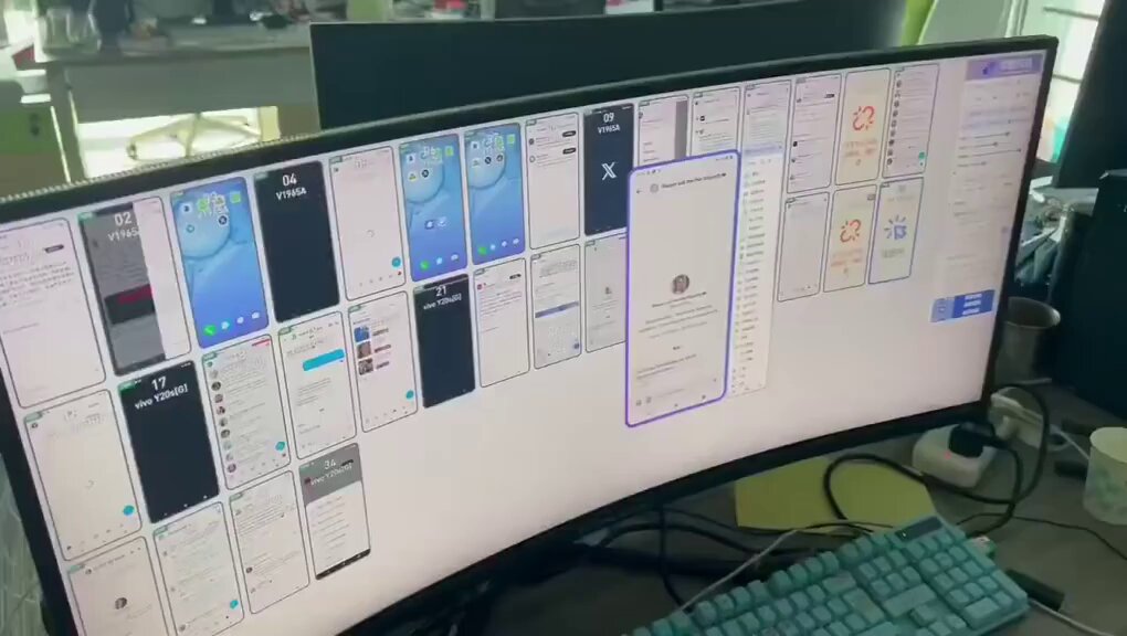 The image shows an office setting with a long computer monitor displaying a screen filled with various apps and icons. The monitor is placed on top of a desk, which also has a keyboard and mouse nearby. A cup can be seen on the right side of the desk. The scene suggests that someone might be working on a project or testing out new software, possibly for an app like kimi agent.