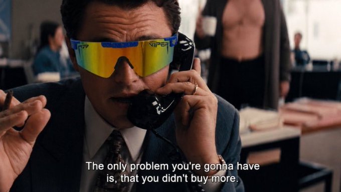 The image features a man wearing sunglasses, talking on a phone while standing next to a table with a cup of coffee on it. The text in the image reads "the only problem you're gonna have is that you didn't buy more". This statement seems to be related to the content of the post about the value of a blue chip coin like $mog, as suggested by the man's sunglasses and his casual attire.