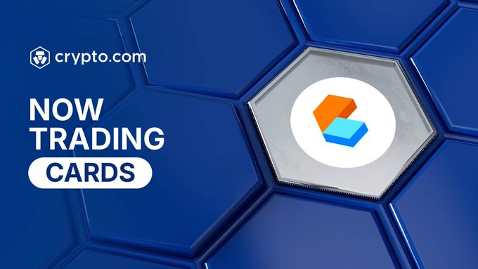 A Crypto.com promotional graphic displays "NOW TRADING" and "CARDS" in bold white text on a blue hexagonal background, alongside the orange and blue Cards Protocol logo, announcing the availability of $CARDS for trading on the platform.