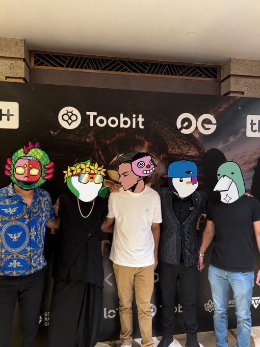 Five people posing in front of a 'Toobit' backdrop, with their faces obscured by various cartoon stickers and emoticons.