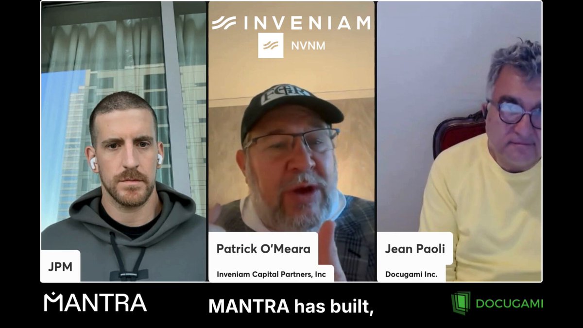 The image shows three men sitting behind a computer screen, with each of them wearing a different colored shirt - yellow, gray, and black. The screen displays information about Inveniam Inc., JVM, and Mantra has built. This suggests that they are discussing or presenting something related to these companies during the community connect event.