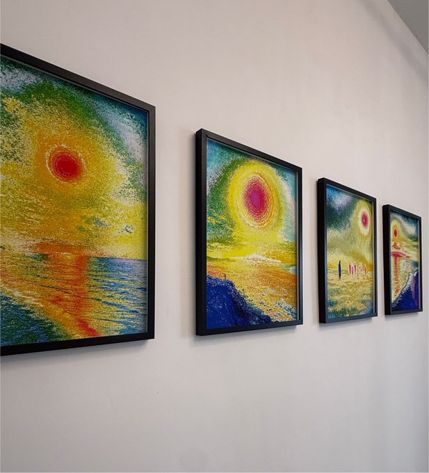 Four framed, colorful landscape paintings featuring bright suns and textured brushstrokes are arranged in a row along a white gallery wall.
