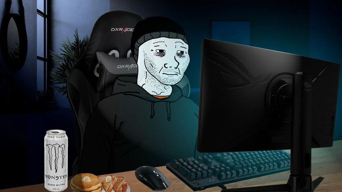 An illustration of a "Doomer" Wojak character sitting in a DXRacer gaming chair at a desk with a monitor, Monster Energy can, and hamburger.