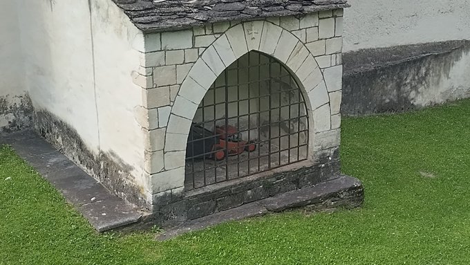 A child's toy car is locked inside a stone building with a metal gate, guarded like a precious treasure. The image humorously parallels the post's idea of "locking away" MEV opportunities behind zk-proofs, where what seems small and hidden is actually the key to a major market shift.