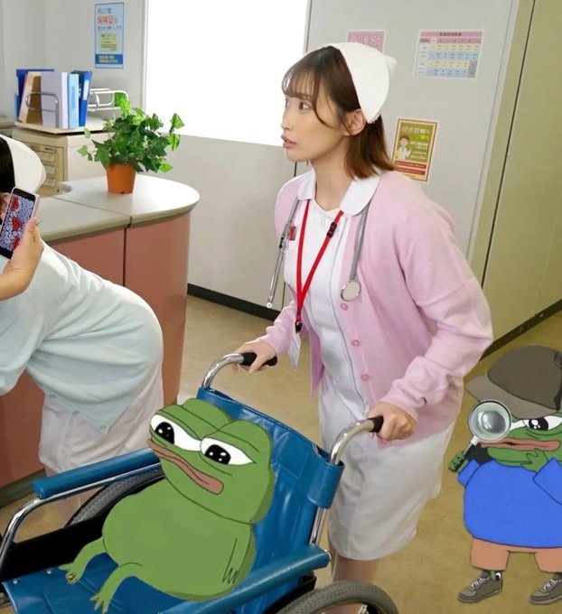 A young woman dressed as a nurse in a pink cardigan and white cap pushes a blue wheelchair decorated with a cartoon Pepe frog through a clinic-like hallway. A partially visible person in white holds a phone at the left edge, and another Pepe character is partly visible on the right.