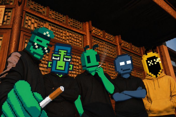 A group of figures wearing pixel-art style masks in green, blue, and yellow pose together in front of a traditional Asian building at night, with one holding a cigarette.