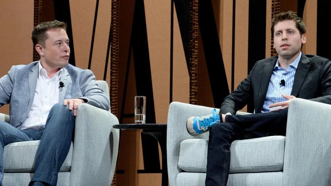 Elon Musk and Sam Altman sit in armchairs during a discussion, relating to the post about their legal dispute over OpenAI's challenge to a secret agreement between Apple, X, and xAI.