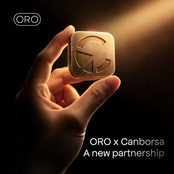 The image features a hand holding up a golden square with an "O" on top of it. The text below the image reads "ORO x Canborsa A new partnership". This suggests that the image might be related to a promotional campaign or advertisement for a company named "ORO" and another company called "Canborsa", possibly discussing a new partnership between them.