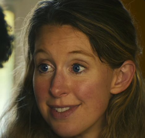 A close-up photograph of a smiling young woman with light brown hair and blue eyes.