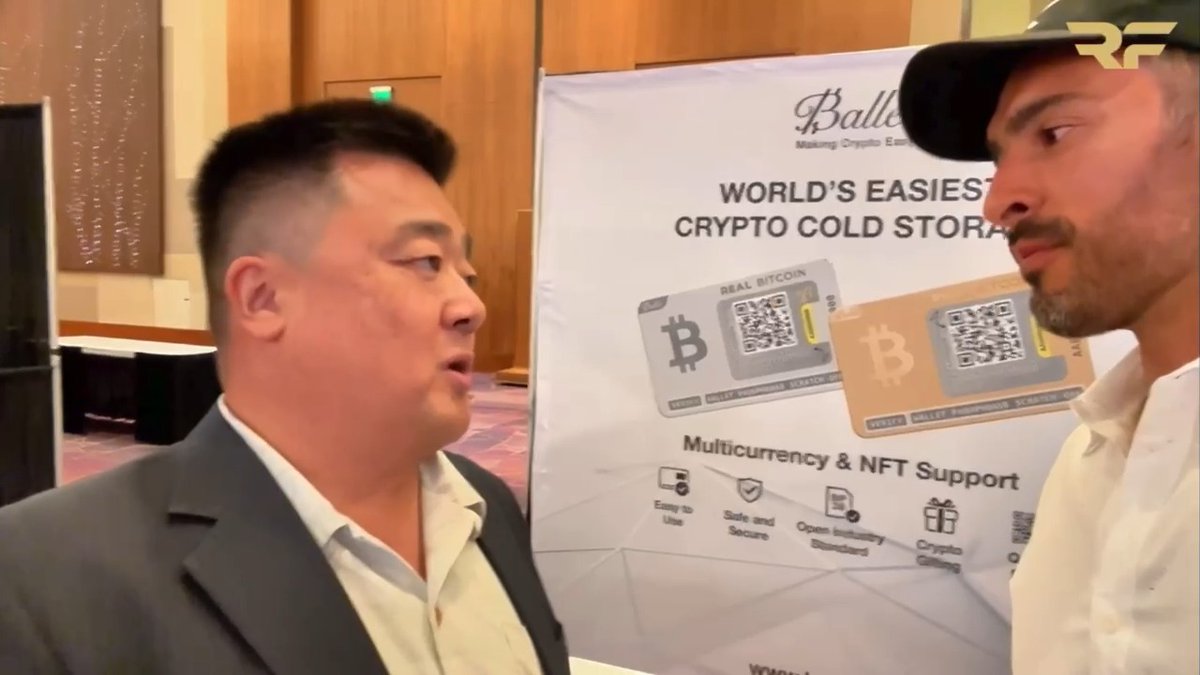 Two men are shown in front of a banner advertising 'Ballet' as the 'WORLD'S EASIEST CRYPTO COLD STORAGE' with 'Multicurrency & NFT Support' and physical Bitcoin cards displayed.