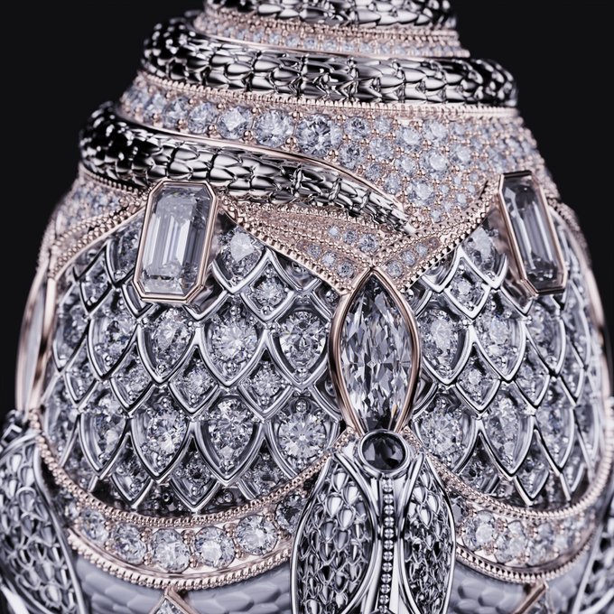 An ornate, diamond-encrusted decorative object resembling a snake-scaled egg or urn, set against a black background.