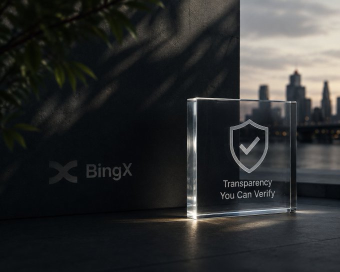 A glass award plaque with the text "Transparency You Can Verify" sits on a dark surface next to a BingX logo, with a city skyline at dusk in the background.